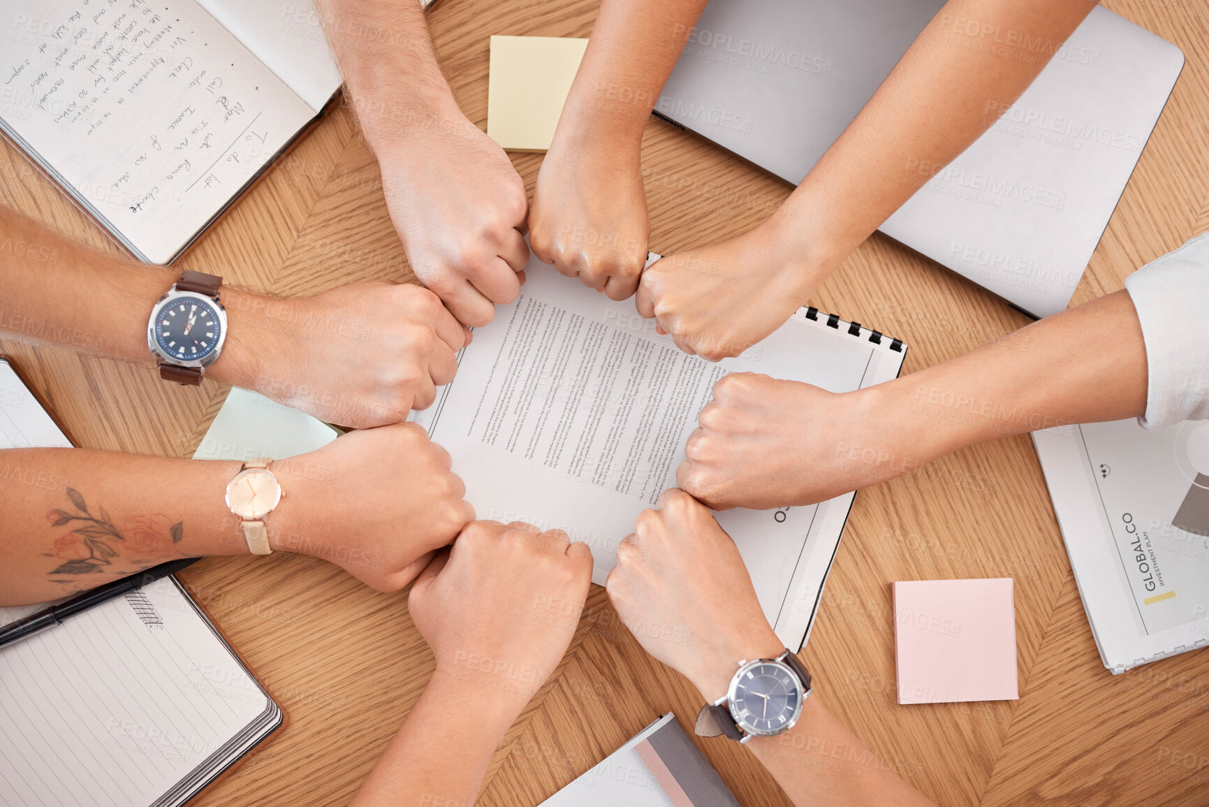 Buy stock photo Team hands, business meeting and fist for collaboration or motivation support at office desk. Diversity, corporate  teamwork strategy and professional partnership trust success planning in workplace