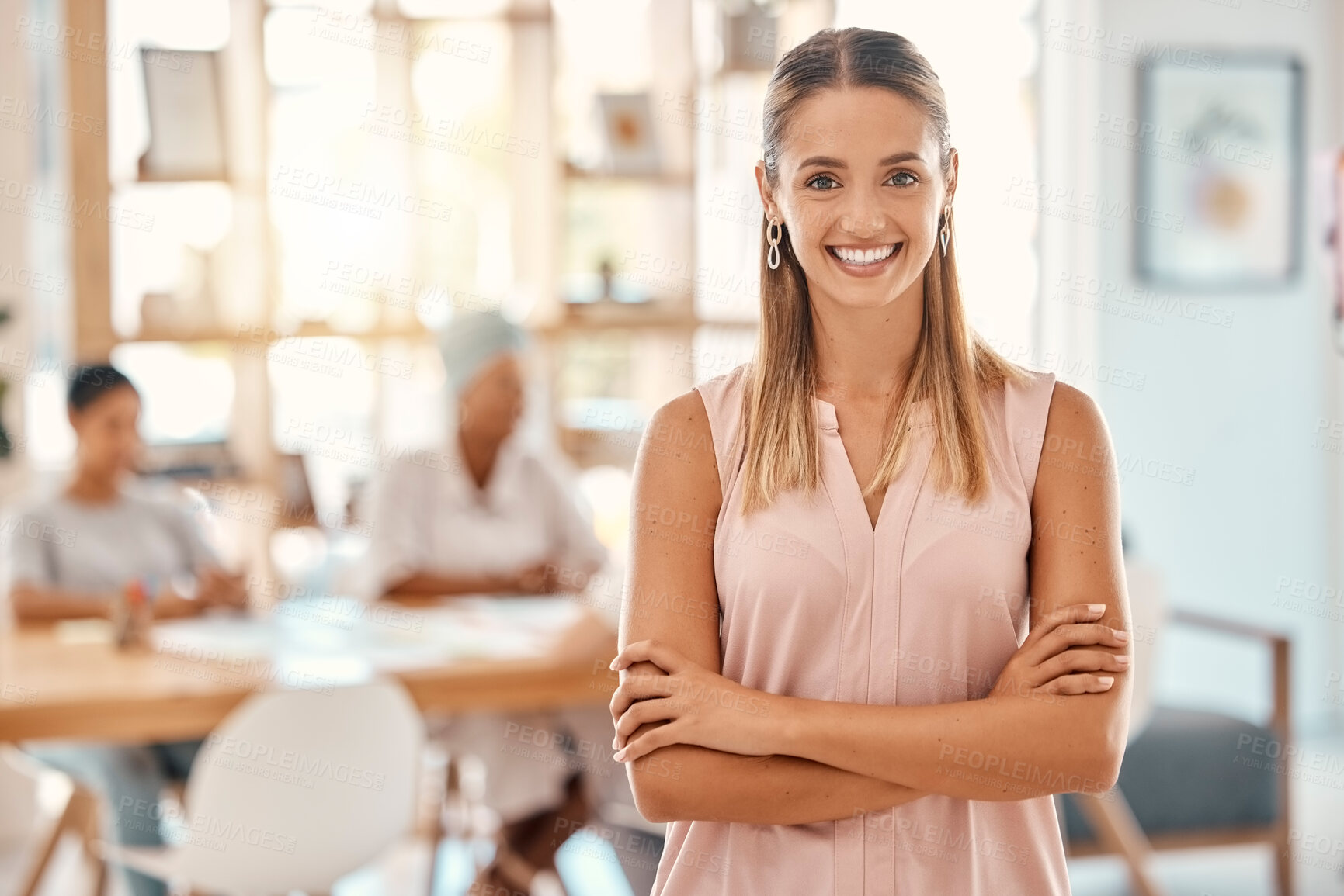 Buy stock photo Confident, happy and smile with a business woman in the boardroom for a planning or strategy meeting. Portrait, motivation and success with a young female employee standing arms crossed in the office