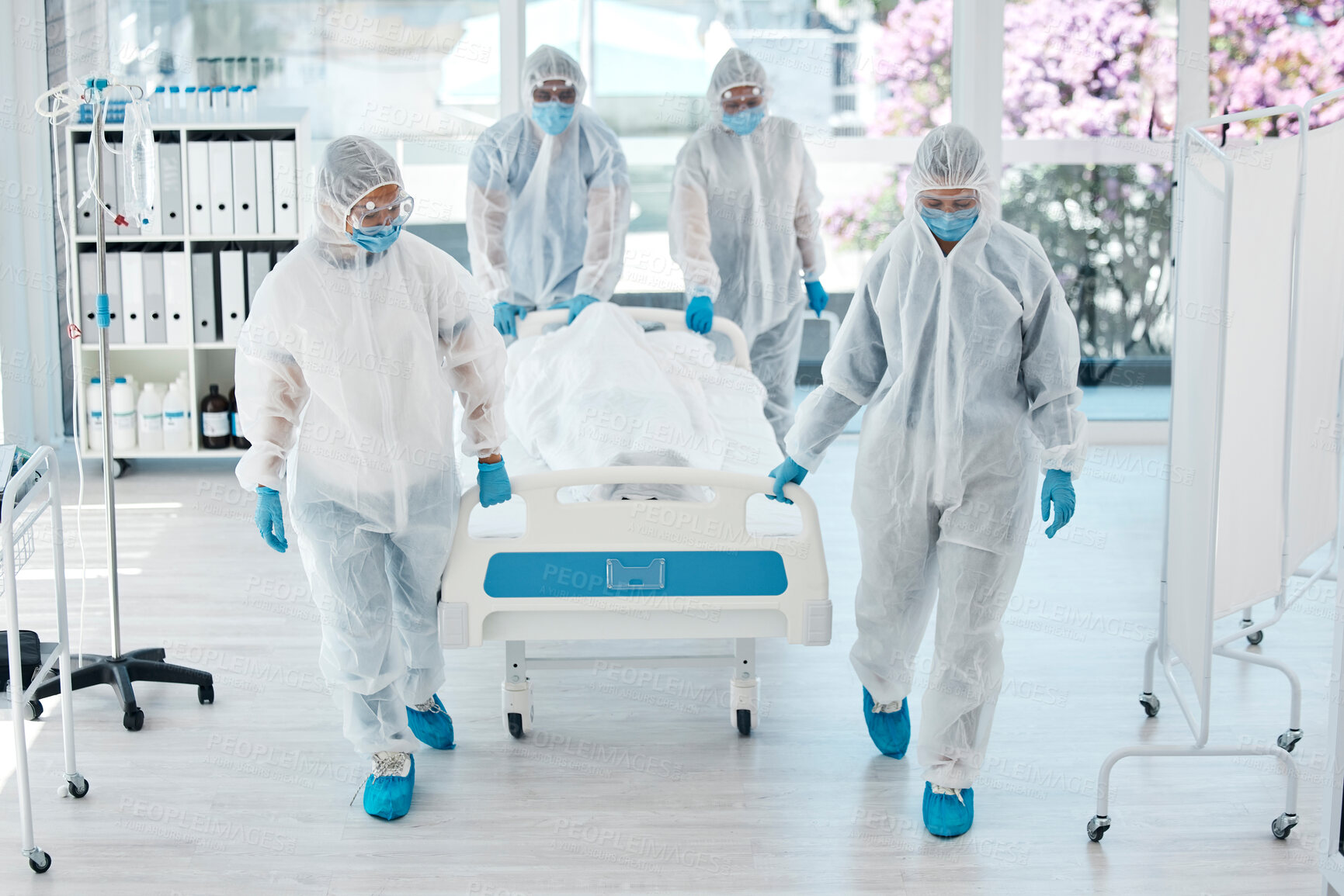 Buy stock photo Covid, ppe and doctors with patient stretcher in hospital for quarantine or testing. Health, safety and medical workers in hazmat suits pushing bed in clinic after death of person with covid 19.