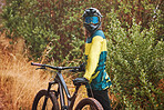 Mountain bike man with cycling helmet taking a break from adventure, action sports and freedom on off road, nature and dirt path. Bicycle athlete stop outdoors after training, workout and biker race 