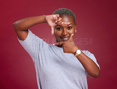 Buy stock photo Black woman, face and hands for frame with smile in picture perfect moment against a studio background. African American female smiling with hand sign or frames for photo capture moment on mockup