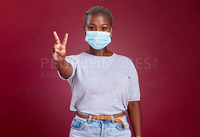 Buy stock photo Black woman, covid face mask or peace sign on red background in studio healthcare vote, wellness opinion or compliance solidarity. Portrait, covid 19 or cool hand gesture on advertising mock up space