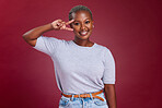 Black woman, peace sign and portrait with smile, happy and hand gesture against a studio red background. Happiness, young girl and hands icon with trendy, fashion and beauty with positive mindset