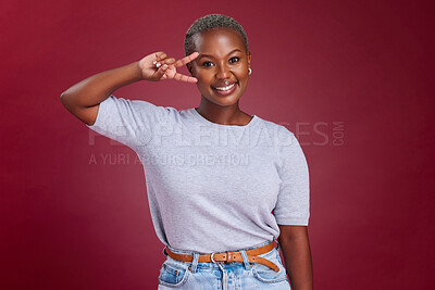 Buy stock photo Black woman, peace sign and portrait with smile, happy and hand gesture against a studio red background. Happiness, young girl and hands icon with trendy, fashion and beauty with positive mindset