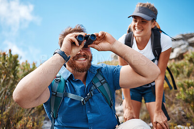 Buy stock photo Hiking, nature and couple with binoculars, happy, smile and relax while watching, looking and explore together. Friends, freedom and hikers bond by woman and man laugh, search and enjoy scenic view