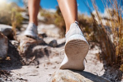 Buy stock photo Shoes, hiking and fitness with a woman closeup walking up a mountain trail for exercise, cardio or adventure. Nature, training and feet with a female hiker stepping on a rock while outdoor for a walk