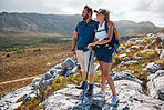 Health, hiking and couple on mountain range for workout, balance and stick to enjoy nature, wellness and relax. Man, woman and hike for bonding, loving and enjoy natural view for health or fitness.