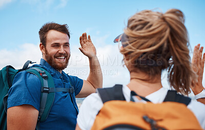 Buy stock photo Couple, high five and hiking for fitness, adventure and exercise in nature while trekking with backpack, happiness and support. Happy man and woman celebrate freedom, travel and holiday in summer