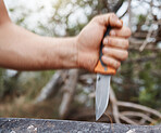 Man, hand and knife in nature forest, sustainability woods and countryside environment for cutting and carving tree bark. Zoom, hiking and camping person with sharp blade, metal weapon or steel tools