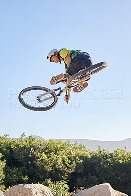 Buy stock photo Bike, extreme sport and outdoor fitness, man does dangerous stunt, sports motivation and training in nature. Exercise, athlete with mountain bike, risk and active with energy and jump over rocks.