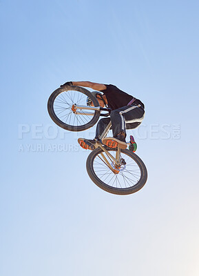 Buy stock photo Mountain bike, speed and sports with a man jumping in the air during a race outdoor against the sky from below. Blue sky, energy and bicycle with a professional male biker or athlete in action