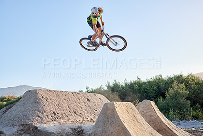 Buy stock photo Nature, bike and cycling sports jump stunt on rocks ramp with fitness, training and exercise man. Athlete, bicycle and sport workout in Canada with mockup for professional athletic advertising.

