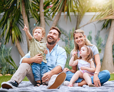Buy stock photo Family garden, bubbles and children with parents together with a smile and quality time. Happy kids, mother and father feeling love and care with a baby looking at bubbles ready for a summer picnic