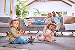 Parents on sofa, children play on floor in home and family time together on weekend morning in Dallas. Streaming movie, young kids bonding with toys and dad searching channel watching tv with mom