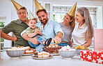 Birthday cake for boy child, home with family and celebrate with food in Texas kitchen. Happy baby smiles in dad's arms, candles on dessert and grandparents at first celebration with gifts on table