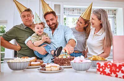Buy stock photo Birthday cake for boy child, home with family and celebrate with food in Texas kitchen. Happy baby smiles in dad's arms, candles on dessert and grandparents at first celebration with gifts on table