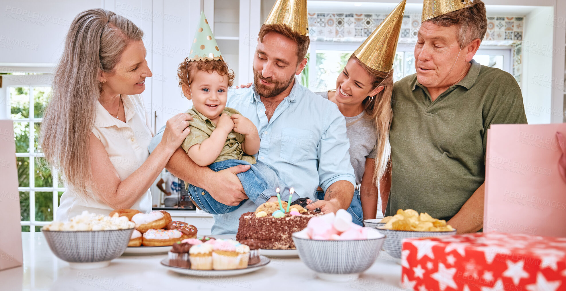 Buy stock photo Children, family and birthday with parents and grandparents celebrating the party of a boy together in the home. Cake, celebration and event with a mother, father and relatives celebrating their son