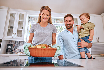 Buy stock photo Cooking, parents and child happy with meal for dinner in the kitchen of their house. Turkey, thanksgiving and mother and father with kid and smile for family food, Christmas or lunch on the stove