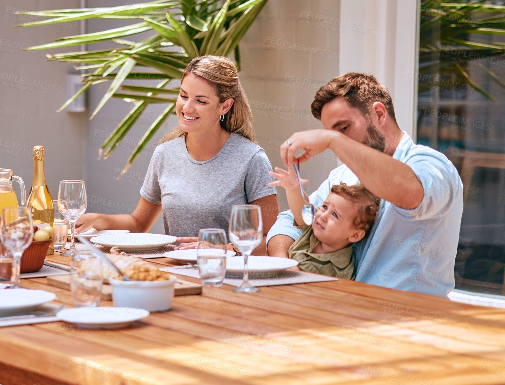 Buy stock photo Food, mother and father with baby at table at an outdoor patio for holiday celebration with champagne and lunch in summer. Happy family, mom and dad with child fine dining together at home or house