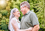 Senior couple hug, retirement and happy, love and care in nature, travel and adventure with holiday and enjoy being retired. Elderly, man and woman smile together, outdoor fun and leisure lifestyle.
