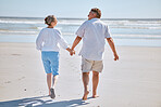 Senior couple, beach and retirement vacation walking, talking and happy about fitness, summer and travel together. Man and woman show happiness, love and marriage support on nature holiday by water