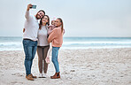 Beach, selfie and happy family smile, relax and bond at the ocean, hug and enjoy trip in nature together. Travel, phone and family picture at the sea while on vacation in Canada with girl and parents