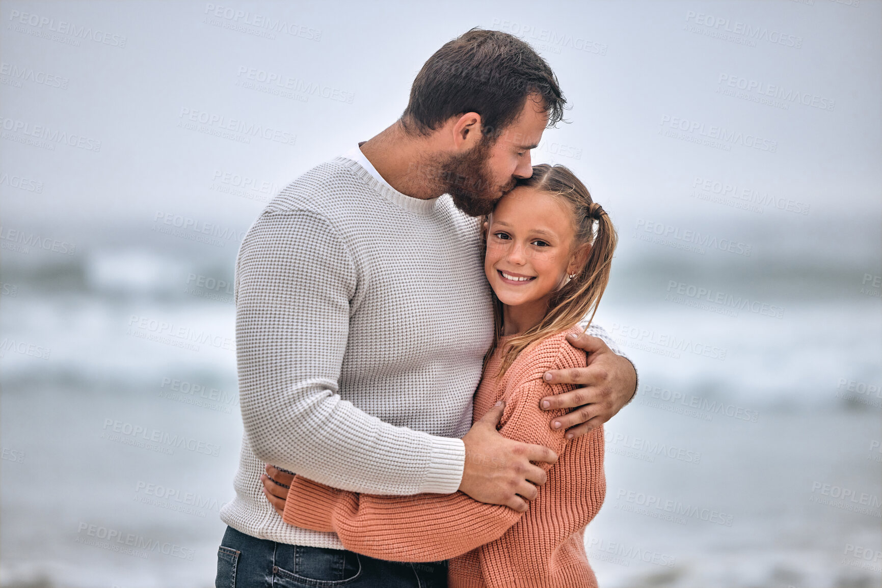 Buy stock photo Family, beach and father kiss girl on vacation, holiday or trip outdoors. Love, care and affection hug of dad and kid bonding, having fun and enjoying quality time together on seashore or ocean coast