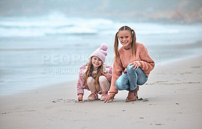 Buy stock photo Sisters, beach and happy with smile, on sand and have fun together being playful, joy and cheerful for holidays. Portrait, siblings or girls at ocean for bonding, loving or seaside vacation for break