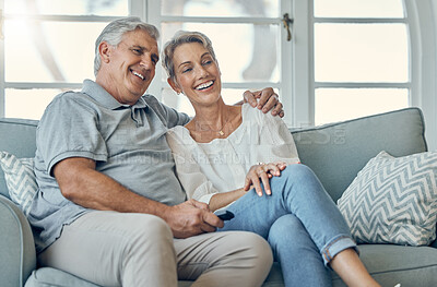 Buy stock photo Happy senior couple, hug and watching TV for entertainment, relax or bonding time together at home. Elderly man and woman relaxing on living room sofa with smile for movie, show or media streaming
