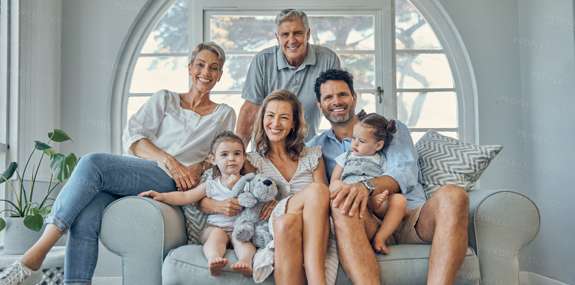 Buy stock photo Happy family, portrait and relax on a sofa with happy, smile and cheerful people in their home together. Love, family and kids with parents and grandparents in a living room, bond and laugh on couch
