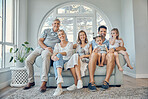Family, children and grandparents with a man, woman and grandkids sitting on a sofa in the home living room together. Portrait, kids and love with girl sister siblings bonding during a house visit