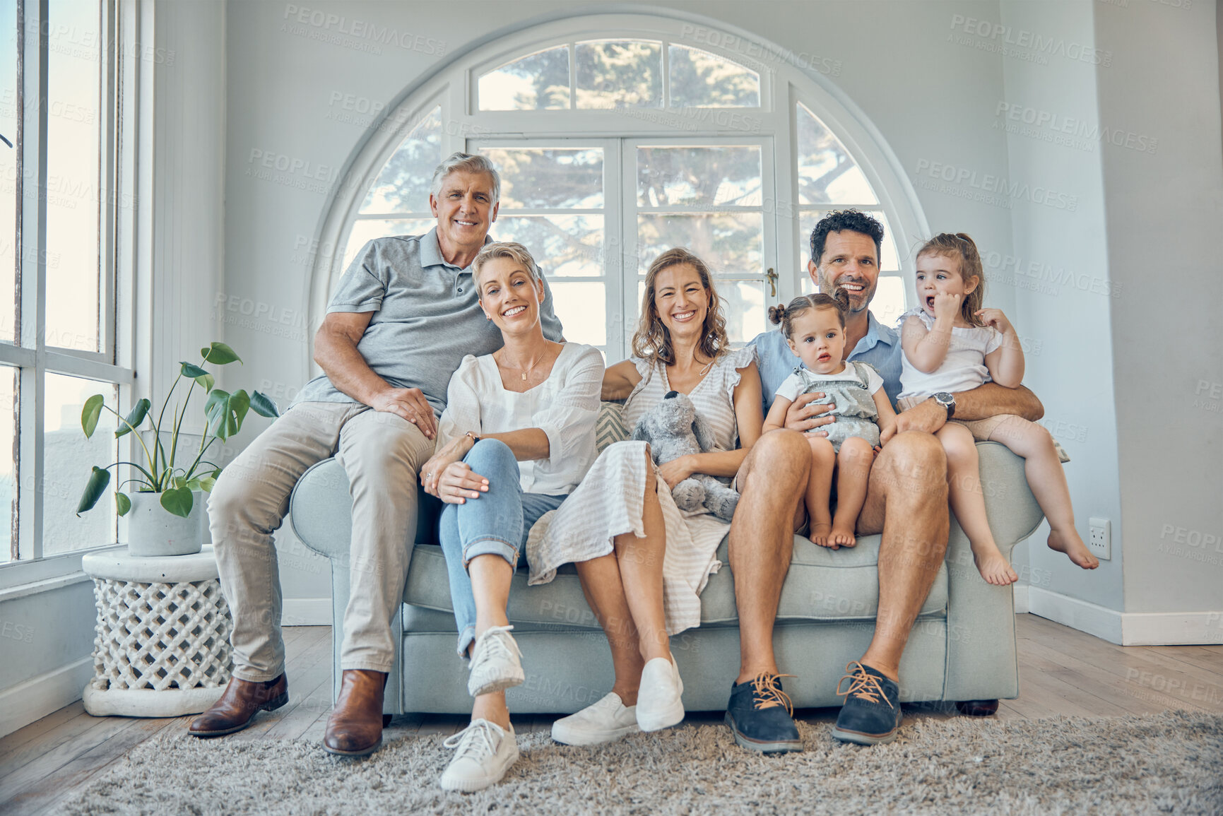 Buy stock photo Family, children and grandparents with a man, woman and grandkids sitting on a sofa in the home living room together. Portrait, kids and love with girl sister siblings bonding during a house visit