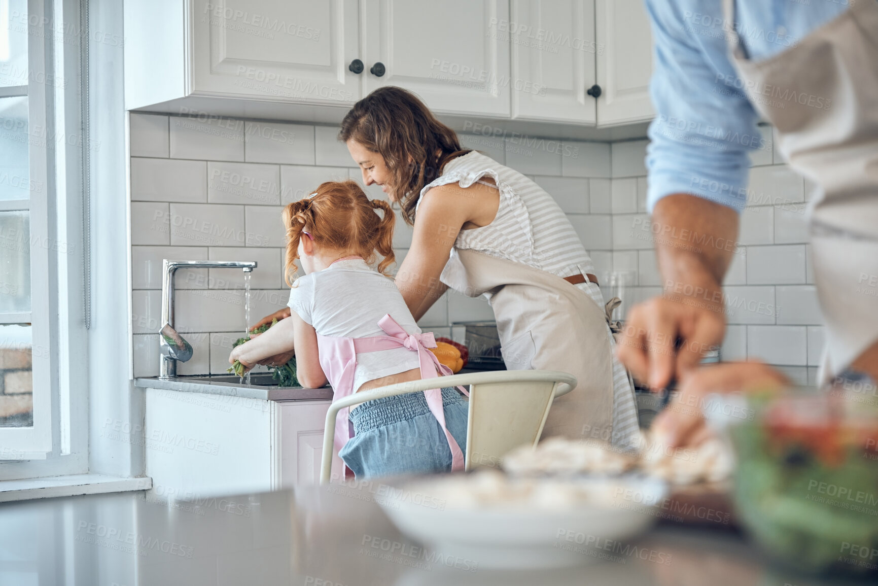 Buy stock photo Washing vegetables, cooking and food with a mother and daughter cleaning ingredients together in the kitchen. Family, help and health with a woman and girl using a sink basin to clean before a meal
