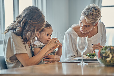 Buy stock photo Family, children and food with a mother, grandmother and girl drinking juice while eating together. Kids, love and lunch with a woman, daughter and grandparent enjoying a meal while bonding at home