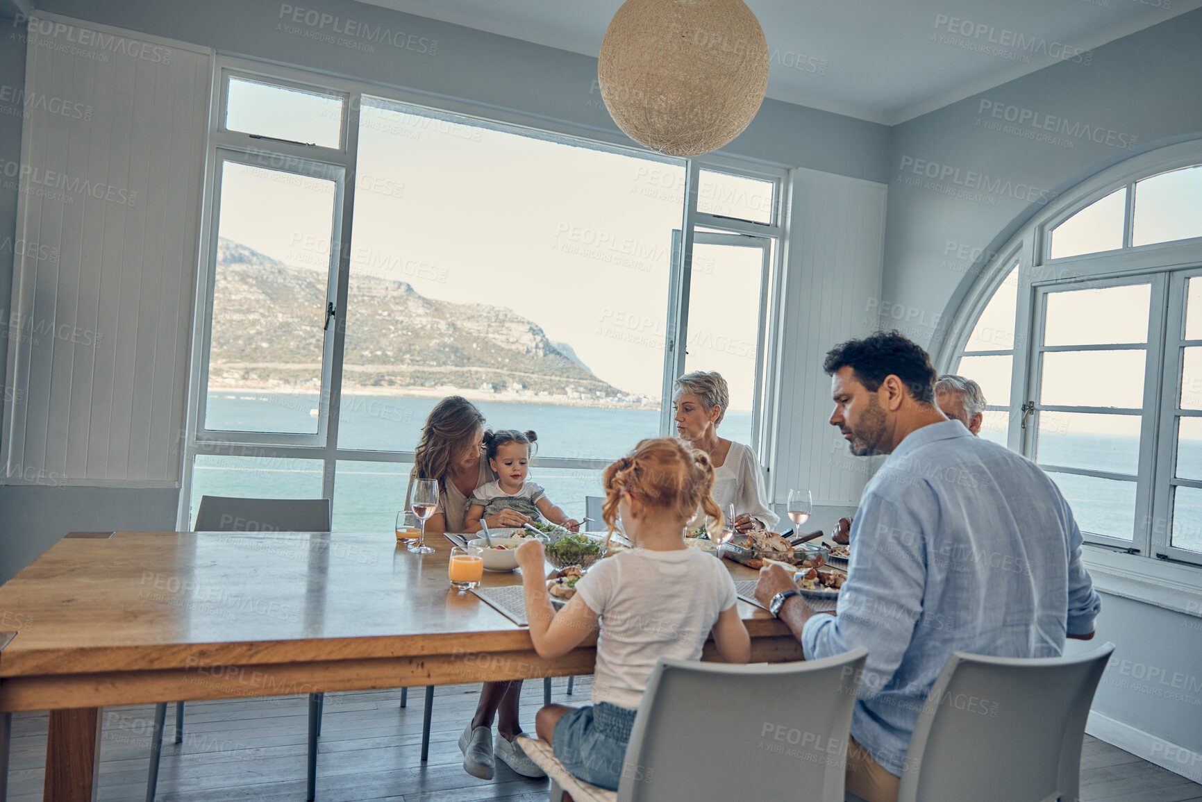 Buy stock photo Big family, food and lunch in home dining room with people sharing a healthy meal. Support, love and relatives eating salad or delicious gourmet chicken on table while enjoying quality time together
