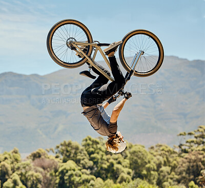 Buy stock photo Mountain bike, man and upside down air jump, action and bicycle stunt, challenge and adventure, freedom or dynamic risk in sky. Biker athlete, sports adrenaline and energy in outdoor competition show