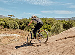 Bicycle, nature and athlete on a dirt trail for an outdoor adventure, journey or training. Bike, sports and man cycling on off road in a field for exercise, workout or action racing in South Africa.