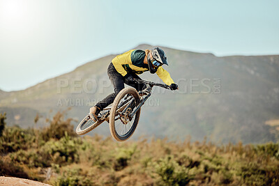 Mountain bike, man and action air jump and bicycle, challenge and adventure, freedom and fast race in nature. Cycling sports athlete, training and energy on mountain for outdoor speed competition