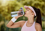 Woman drinking water bottle on break at tennis game, training or workout in summer for hydration. Tennis player girl, drink liquid for health, wellness or hydrate in sun at sports contest competition