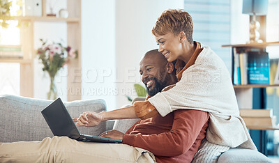 Buy stock photo Pointing, laptop or bonding mature couple on sofa in house or home living room on real estate, property or apartment internet search. Smile, happy or hug black woman and man with mortgage technology