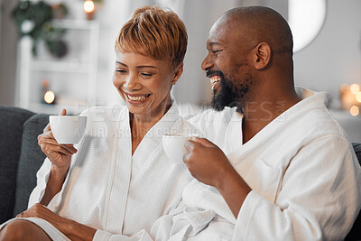 Buy stock photo Coffee, love and mature couple on a sofa, happy and laughing while drinking coffee and relax in bathrobe in living room. Black family, tea and senior man and woman enjoy morning conversation on couch