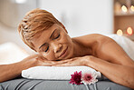 Relax, massage and woman being peaceful, calm and stress free for tension, laying on table and physical therapy treatment. Spa, mature female and enjoy body care for  wellness, health and resting.