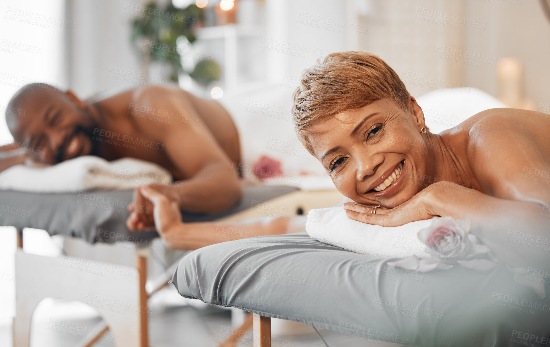 Buy stock photo Love, massage and couple holding hands at a spa in celebration of a happy marriage anniversary holiday. Smile, romance and relaxed black woman with a happy romantic African partner at a luxury resort