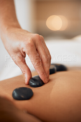 Buy stock photo Hot stone therapy, massage and relax in a luxury spa resort for wellness treatment, relaxation therapy with hand and organic healing. Woman in a beauty salon, natural skincare and body health energy 