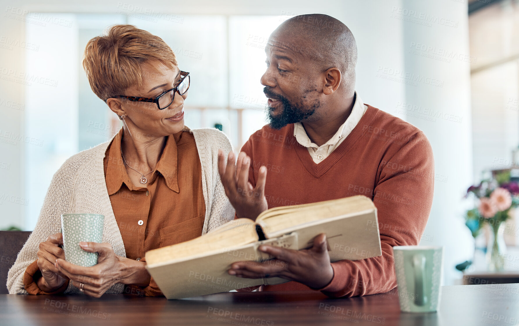 Buy stock photo Couple reading bible, home faith and talking about religion with coffee for learning, study and education. Black man, holy book in hand and spiritual conversation about christianity, God and worship