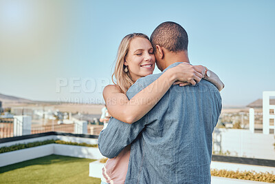 Buy stock photo Couple, love and hug on city building rooftop for date, romance and quality time while dancing and happy together. Interracial man and woman on vacation in Cape town in summer for cityscape travel
