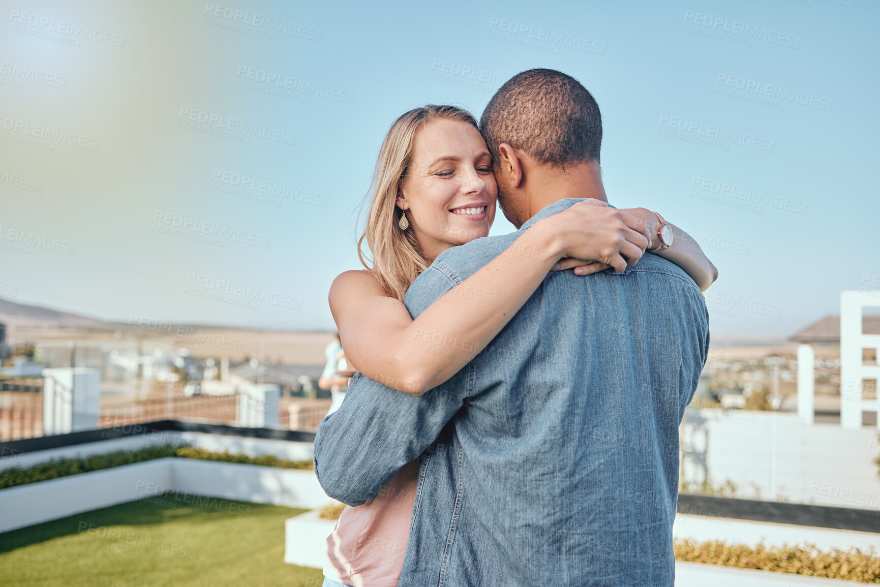 Buy stock photo Couple, love and hug on city building rooftop for date, romance and quality time while dancing and happy together. Interracial man and woman on vacation in Cape town in summer for cityscape travel