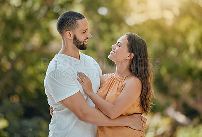 Buy stock photo Happy, love and couple hug in a park, bond and talking and quality time against a nature, tree and bokeh background. Happy, smile and woman with man enjoying trust, support and relationship in forest