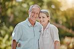 Happy, love and portrait of a senior couple standing in a green garden while on a picnic on vacation. Happiness, smile and elderly man and woman in retirement embracing in a park on holiday in Canada