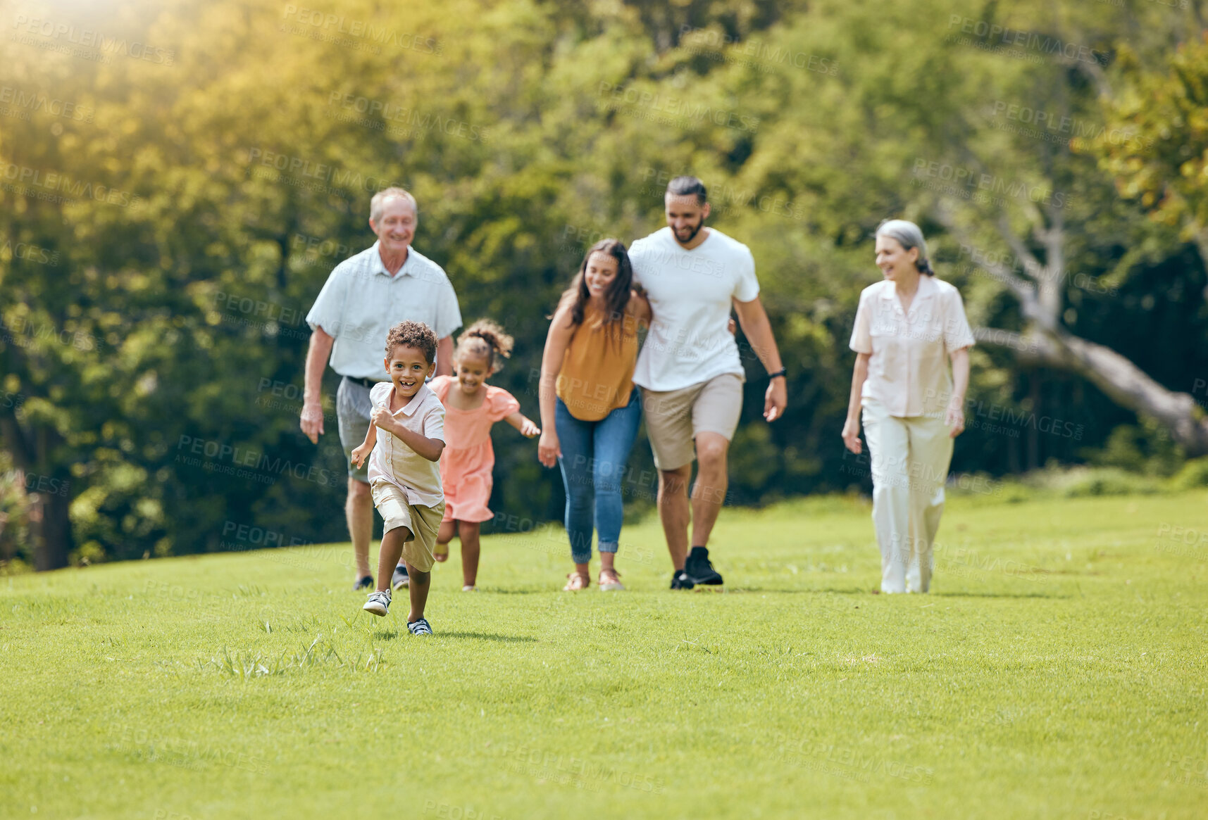 Buy stock photo Grandparents, parents and children walking in park, happy and bonding outdoor, loving together and quality time. Family, love and vacation in summer with smile, laugh and have fun with kids and relax
